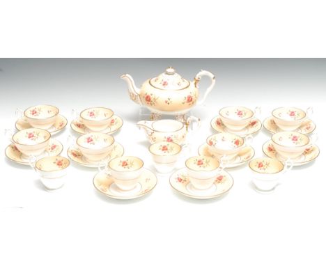 An early H &amp; R Daniel part tea service, painted pink flowers on a peach ground, comprising squat teapot, cream jug, eight