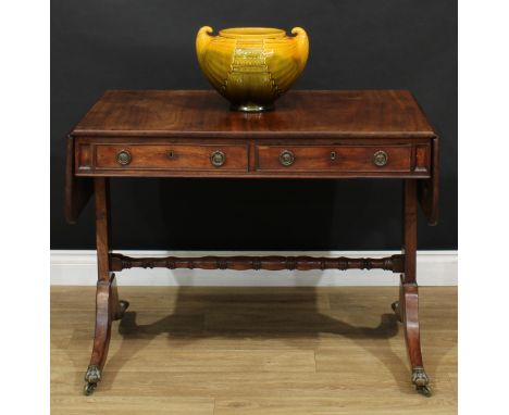 A Regency mahogany sofa table, rounded rectangular top with fall leaves above a pair of frieze drawers, blind to verso, recta