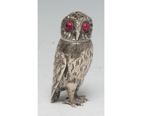 A Victorian silver novelty pepper, as an owl, ruby glass eyes, 7cm high, George John Richards, London 1850 
