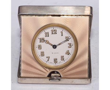 An Art Deco silver and guilloche enamel travelling boudoir timepiece, hinged cover engine turned with radiating bands and geo