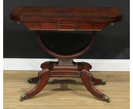 A Regency mahogany card table, hinged rosewood crossbanded top enclosing a baize lined playing surface, U-shaped support, inc