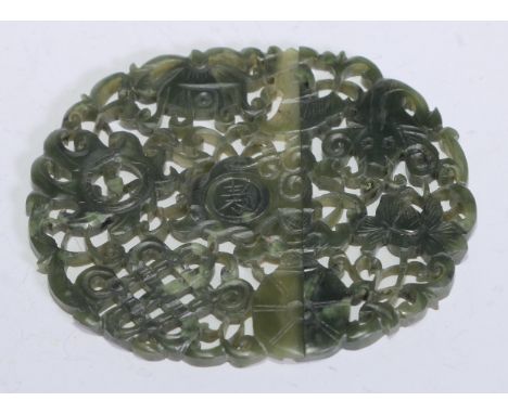 An early 20th century Chinese jade two-part buckle of dark green colour, carved and pierced as a thin oval plaque with catfis