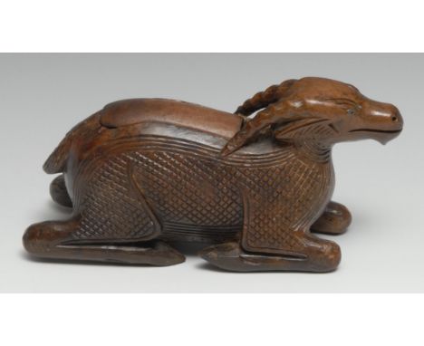 A 19th century treen novelty table snuff box, carved as a recumbent goat, sliding cover, 18cm long 