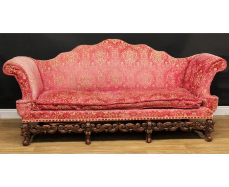 A William &amp; Mary Revival sofa, shaped back, outswept arms, stuffed-over upholstery, squab cushion, shaped front stretcher