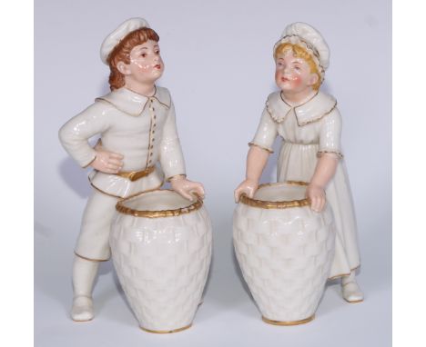 A pair of Royal Worcester figures,  of a boy and girl holding a woven basket, lightly coloured in flesh tomes and gilt,  17cm