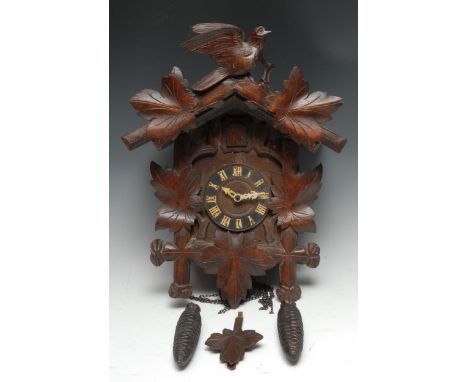 A Black Forest cuckoo clock, 11cm dial with Roman numerals, the movement striking on a gong, the case carved with borders of 