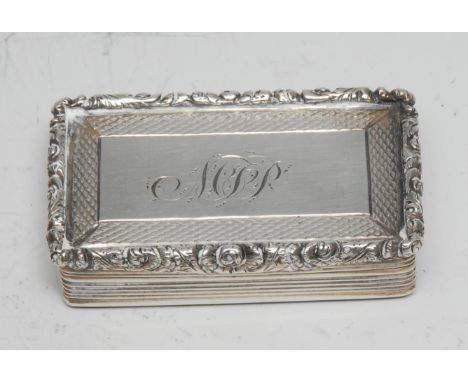 A William IV silver rectangular snuff box, hinged cover with cast foliate border, engine turned and reeded, gilt interior, 5c