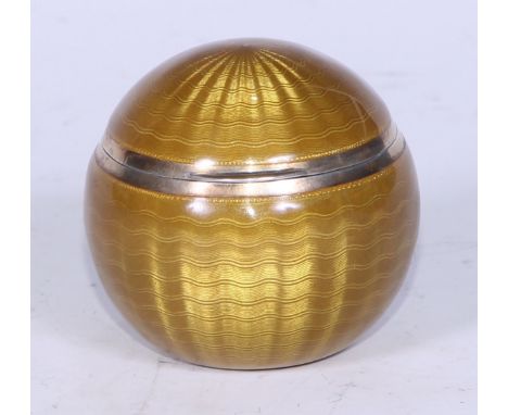 A mustard yellow guilloché enamel spherical box, silver gilt interior, engine turned, stamped 84, 5cm dia. 