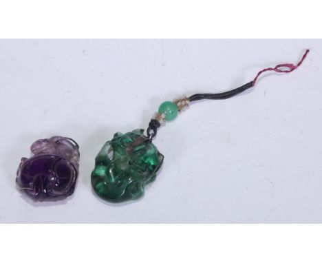 A Chinese amethyst pendant carved as a squirrel on a giant peach, 3.5cm high; another Chinese two cat pendant, 3.5cm high. 