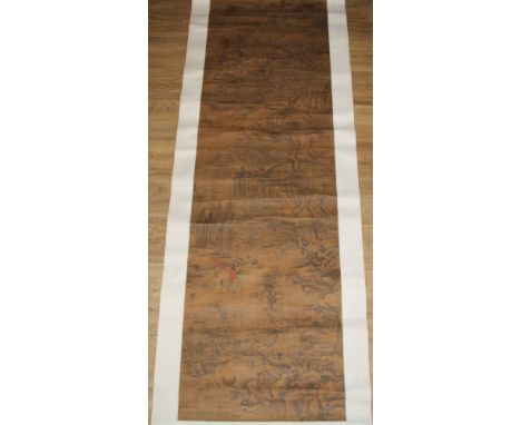 Chinese School, after Li Tang, a scroll, on linen, with a monumental landscape with figure on a horse, 170cm x 51cm 