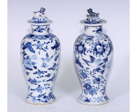 A 19th century Chinese ovoid vase and  cover, decorated in underglaze blue with stylised birds and foliage, slightly domed co