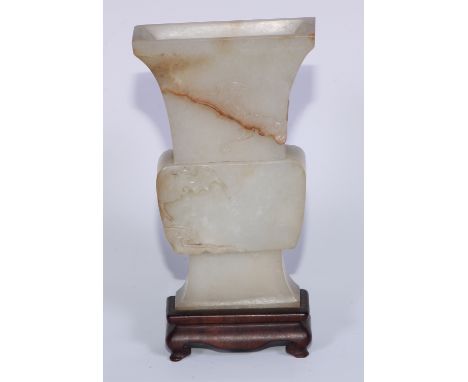 A Chinese flattened celedon pale jade archaic vase, carved with bats, 14cm high 