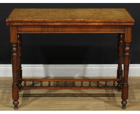 A Victorian Aesthetic Movement walnut card table, quarter-veneered folding top enclosing an inset baize-lined playing surface