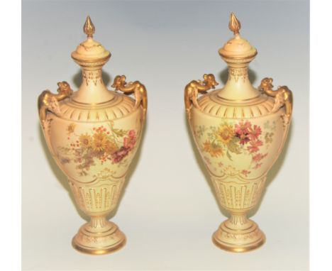 A pair of Royal Worcester two handled pedestal vases and covers, printed and painted with spring flowers, 35cm high, printed 