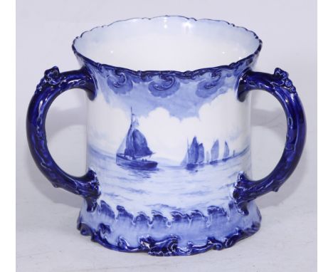 a Royal Crown Derby three handled loving cup, painted inthe manner of W E J Dean, in tones of blue with a continuous seascape