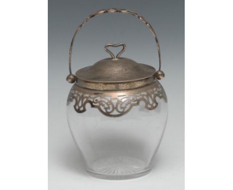 A late Victorian/Edwardian silver mounted clear glass biscuit barrel, swing handle, push-fitting cover with heart shaped fini