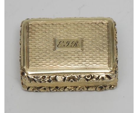 A George III silver-gilt vinaigrette, engine turned and outlined with foliate borders, hinged cover enclsoing a pierced grill