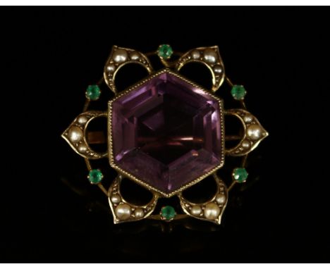 An unusual amethyst, seed pearl and emerald flowerhead brooch, the large hexagonal faceted amethyst within six openwork styal