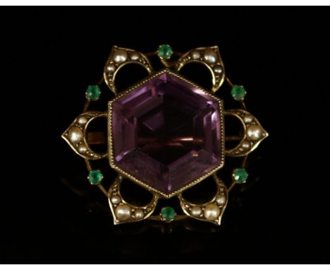 An unusual amethyst, seed pearl and emerald flowerhead brooch, the large hexagonal faceted amethyst within six openwork styal