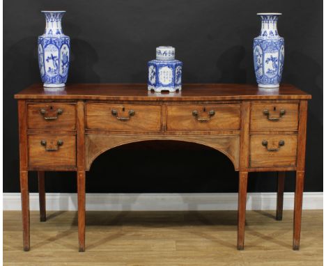 A George III mahogany sideboard, slight bow-centre top above a pair of frieze drawers, flanked to the left by  a deep drawer,