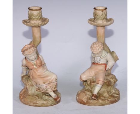 A pair of Royal Worcester figural candlesticks, with children sleeping against a tree, in blush ivory tones, 23cm high, print