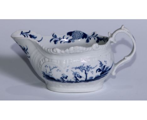 A Worcester Two Porters pattern cream boat, decorated in underglaze blue with figures and foliage within relief moulded carto
