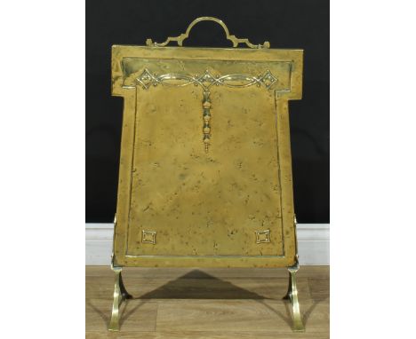 An Arts &amp; Crafts brass firescreen, embossed with stylised bell husks, sledge base, 77cm high, 46cm wide 