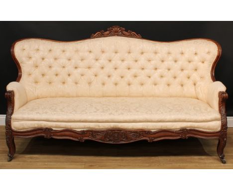 A 19th century Anglo-Indian hardwood sofa, shaped serpentine back with shell and scroll cresting, stuffed-over deep-button up