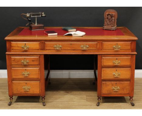 A late Victorian twin pedestal desk, rectangular top with inset writing surface above three frieze drawers, three further dra