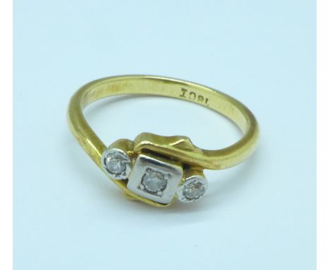 An 18ct gold and three stone diamond crossover ring, 3.5g, M