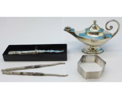 A silver Aladdin's lamp/burner, a silver napkin ring, a silver crab pick and two other picks, 98g weighable silver