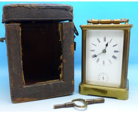 A French brass and four glass sided carriage clock with alarm, with key, boxed