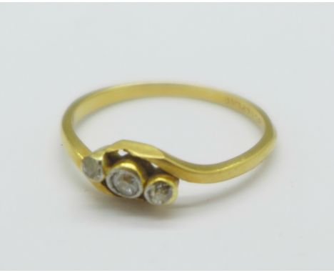 An 18ct gold and three stone diamond crossover ring, 2g, O