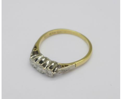 An 18ct gold and three stone diamond ring with diamond shoulders, 2.5g, P