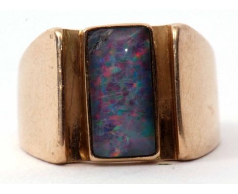 A 9ct stamped opal ring, a stylised design featuring a bezel set rectangular shaped cabochon opal (chipped), size S, gross we