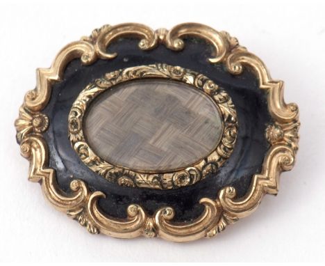 Victorian mourning brooch, the oval glazed centre with plaited hair panel, within a black enamel surround, the verso engraved