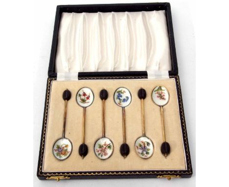 Cased set of six Elizabeth II silver gilt and enamelled coffee spoons, each with coffee bean finials and plain wire work hand