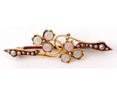 Opal and seed pearl brooch, a design of two flowerheads, each with three circular cut opals, highlighted throughout with grad