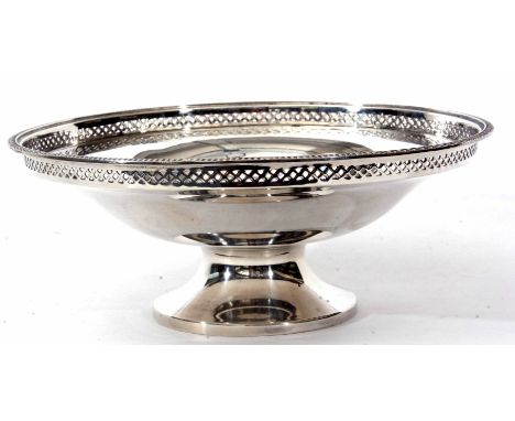 George V footed bowl of plain polished circular form with cast and applied rim and narrow pierced gallery raised on a spreadi