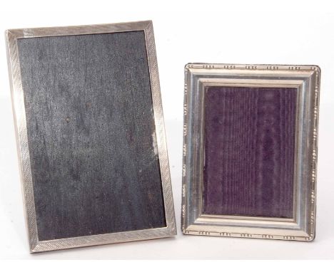 Mixed Lot: comprising two various silver mounted easel backed photograph frames, the first of engine turned form with black f