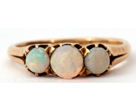 Three stone opal ring, featuring three graduated cabochon cut opals, individually claw set and raised between pierced taperin