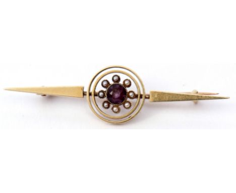 A 15ct amethyst and seed pearl bar brooch, a plain polished open work design with a central bezel set amethyst surrounded by 