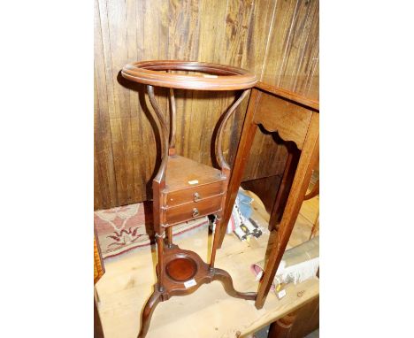 A mahogany "basin" stand of early 28th century design, fitted two drawers, on splay supports, 12" dia 