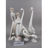 A Lladro figure of a lady holding an urn, 12 1/2" high, a pair of model swans and other Lladro