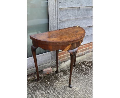 A burr walnut fold-over semicircular card table with shaped frieze on four cabriole supports 30" wide, and a mahogany semicir