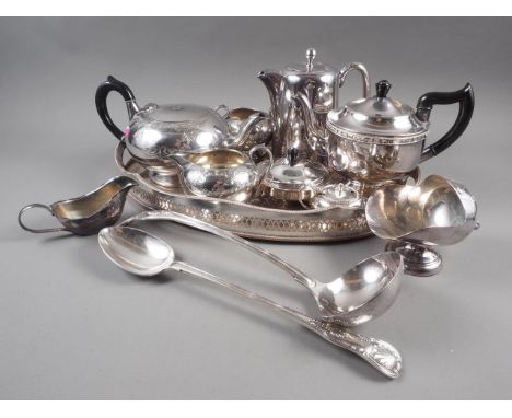 A silver plated basting spoon, a plated ladle, two teapots, a tray and other items 