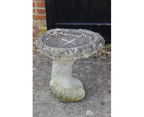 A cast stone bird bath, on "tree trunk" support, 17" wide x 18" high 