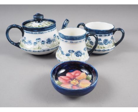 A late 19th century Macintyre three-piece teaset, comprising a teapot, a sugar basin and a cream jug, and a Moorcroft pin dis