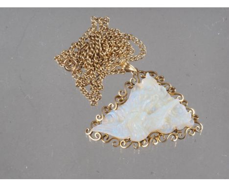 A carved opal tablet decorated with a bird, in 14ct gold pendant frame, on a 9ct gold curb link chain, 18.2g overall 