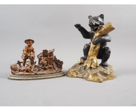 A bronze and gilt metal inkwell, formed as a bear grasping a tree trunk, 7 1/2" high, another inkwell formed as a farmer with